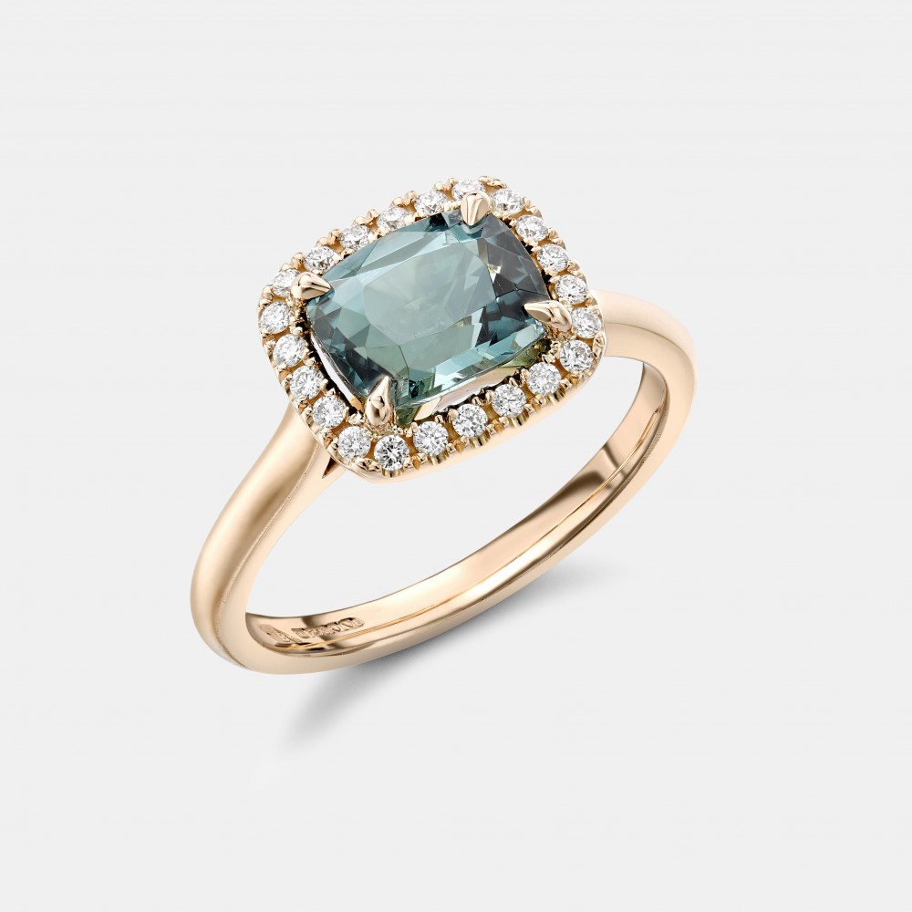 Robert Bicknell's beautiful blue tourmaline ring, surrounded by a halo of 22 colourless diamonds and set in 18k yellow gold.
